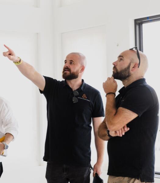 Architect and builder reviewing plans on site at a Geelong custom home by Fox Building Group.