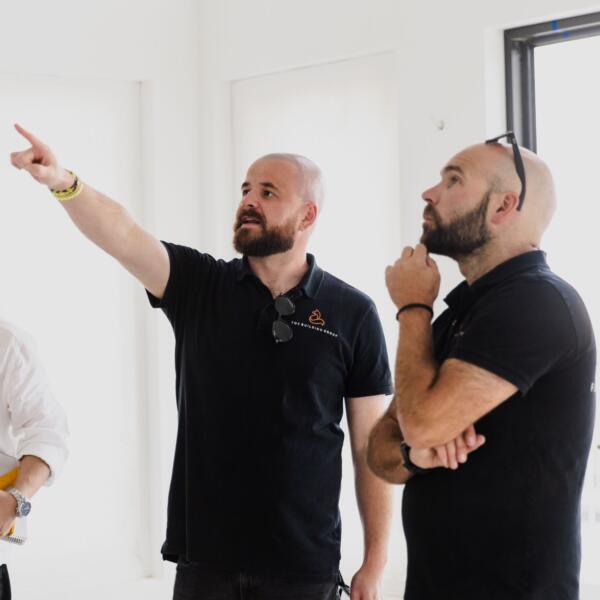 Architect and builder reviewing plans on site at a Geelong custom home by Fox Building Group.