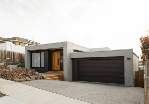 Modern minimalist new build home in Highton with a sleek facade, featuring natural timber entry