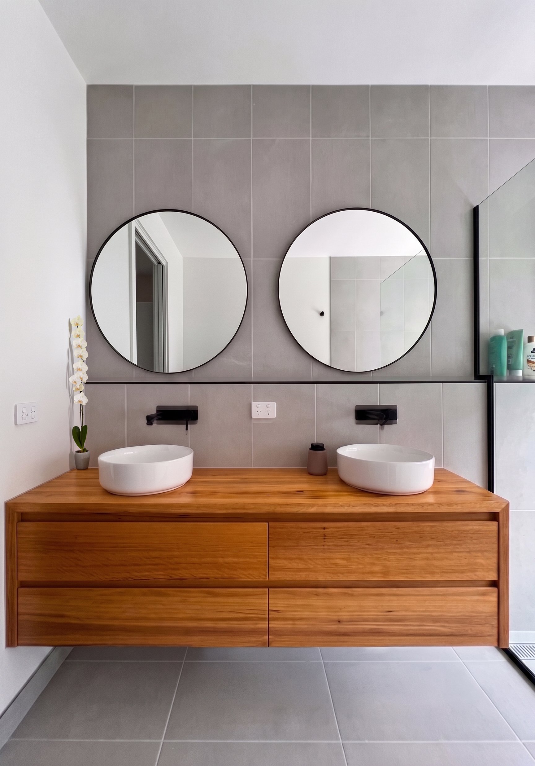 Timber Double Vanity With Round Mirrors And Matt Black Tapware In A Custom Home Builder Torquay Bathroom