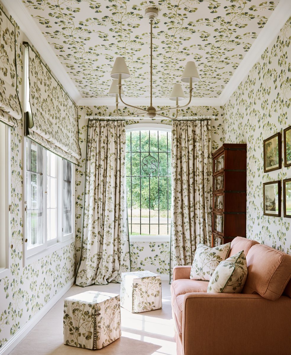 A Sunroom Where The Walls, Ceiling, Curtains, And Ottomans Are All Covered In A Matching Green And White Colefax And Fowler &Apos;Greenacre&Apos; Botanical Print, Featuring A Coral Sofa.