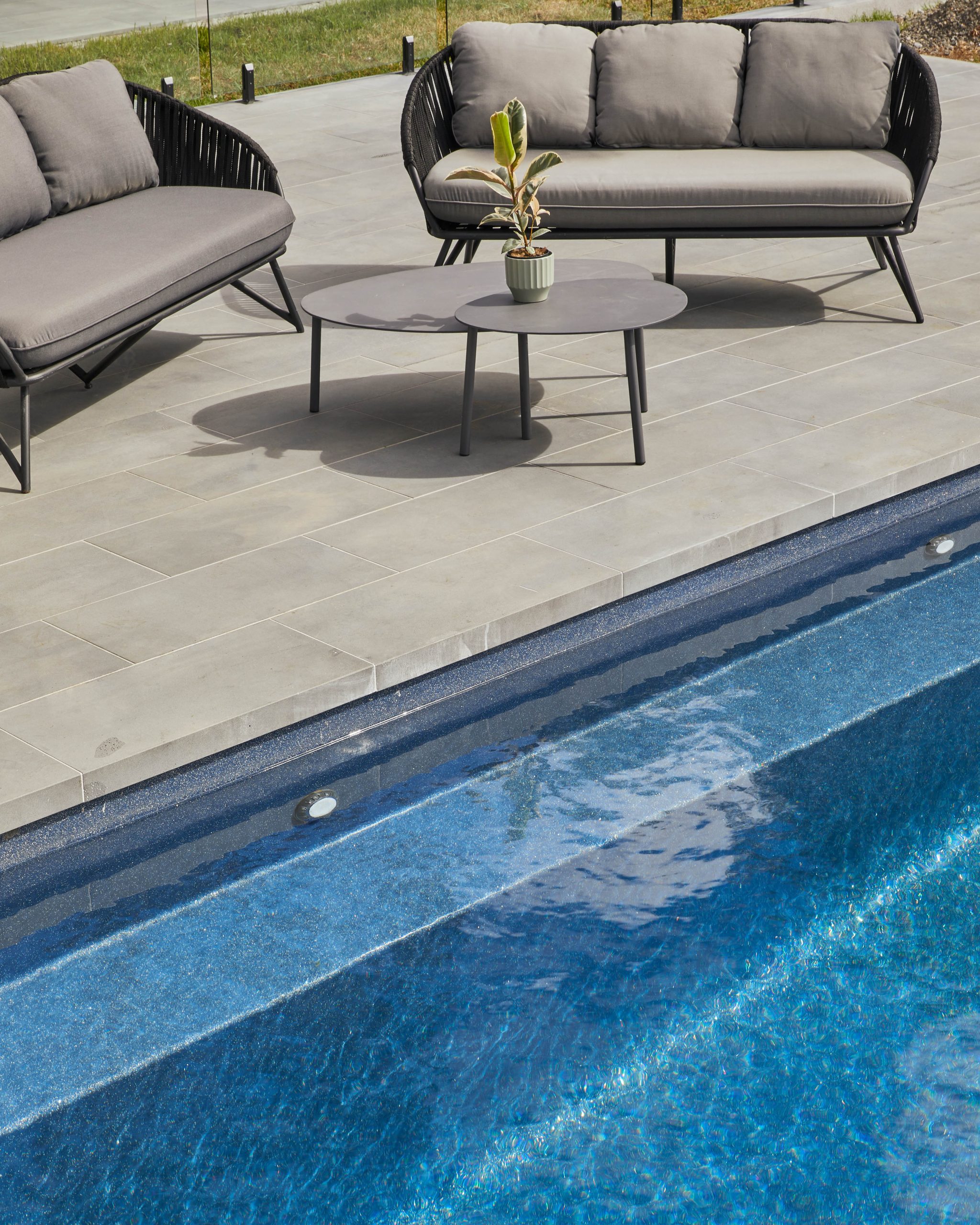 Pool Edge Detail With Blue Tiled Interior And Bluestone Paving
