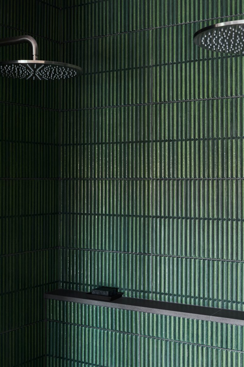 Dual Brushed Metal Rain Shower Heads Set Against Green Fluted Tile
