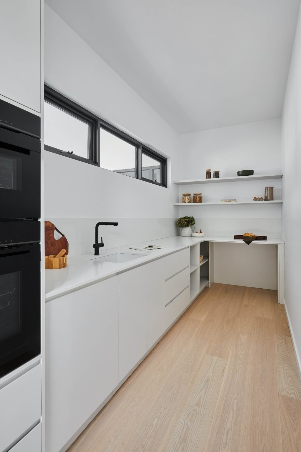 Kitchen Island With Matte Black Tapware And A View Of The Paddock And Shed Beyond