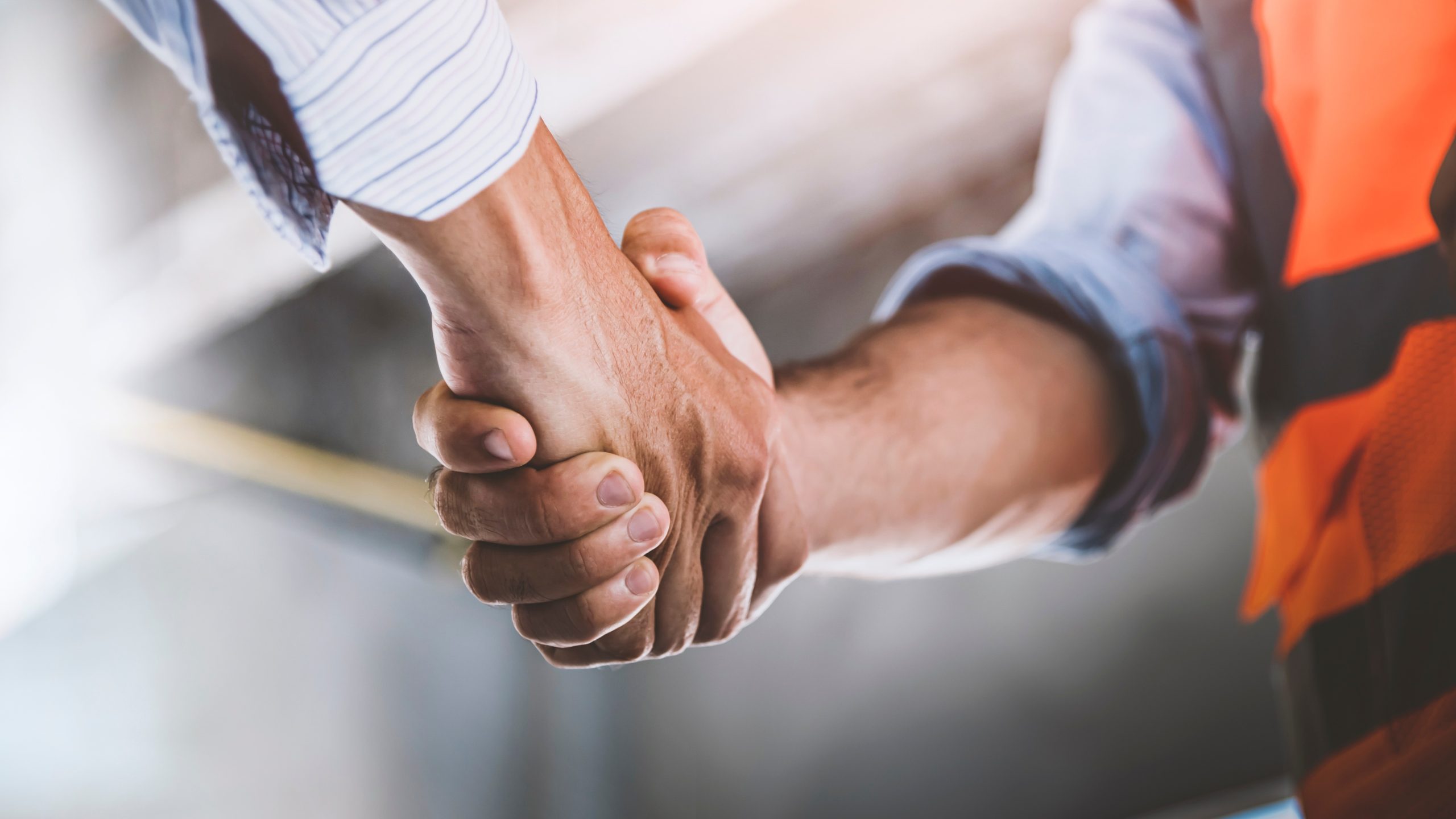 Handshake Between Builder And Client Symbolising Trust And Agreement In Pre-Construction Services By Fox Building Group In Victoria.