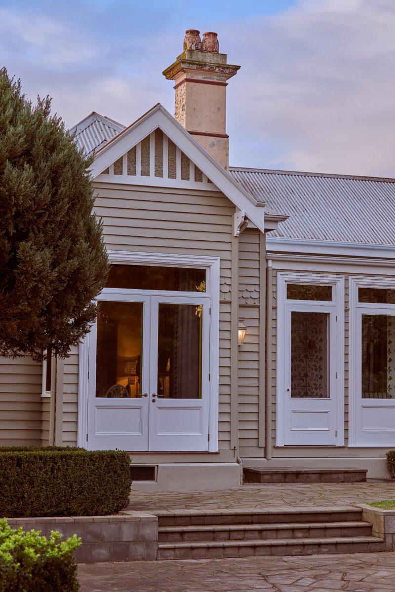 Restored Heritage Facade And New French Doors At Tullynagee Homestead, Showcasing Original Masonry Texture Against Crisp Weatherboards.