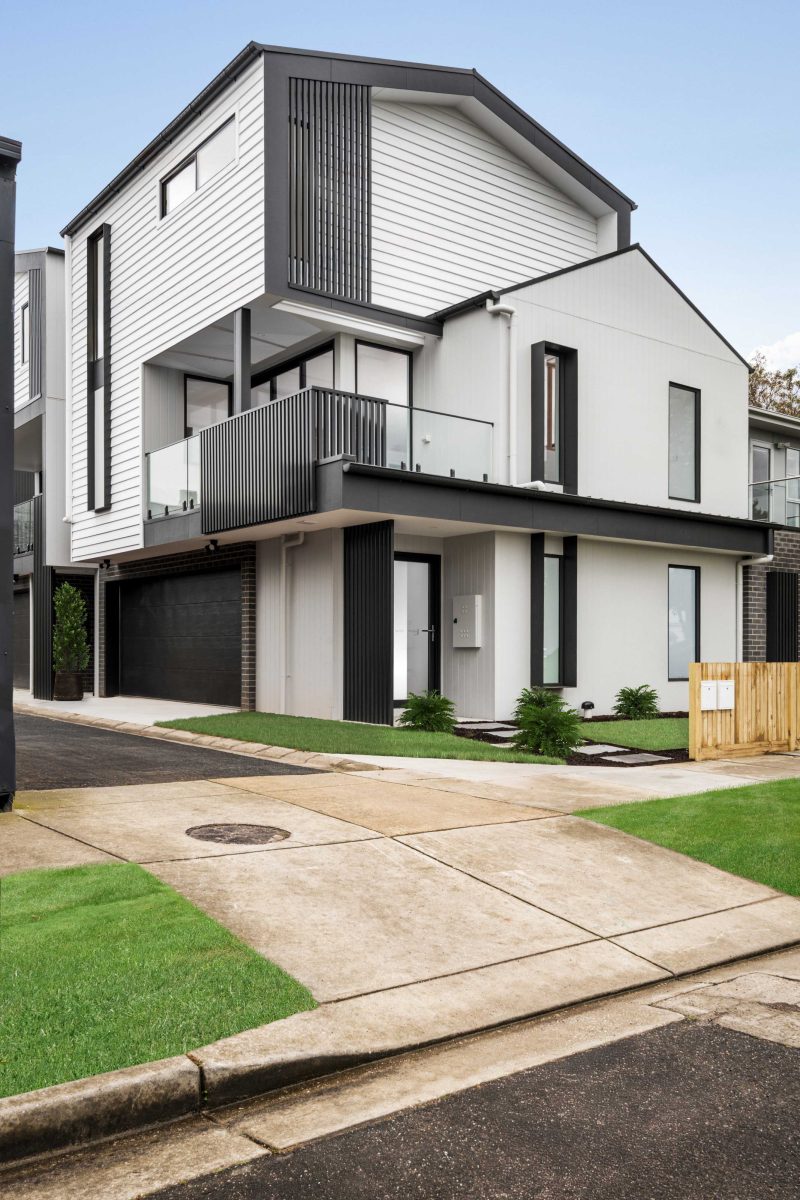 Townhouse Development South Geelong – Upward View Of The Gable Roof Form And White Weatherboard Cladding Against Blue Sky