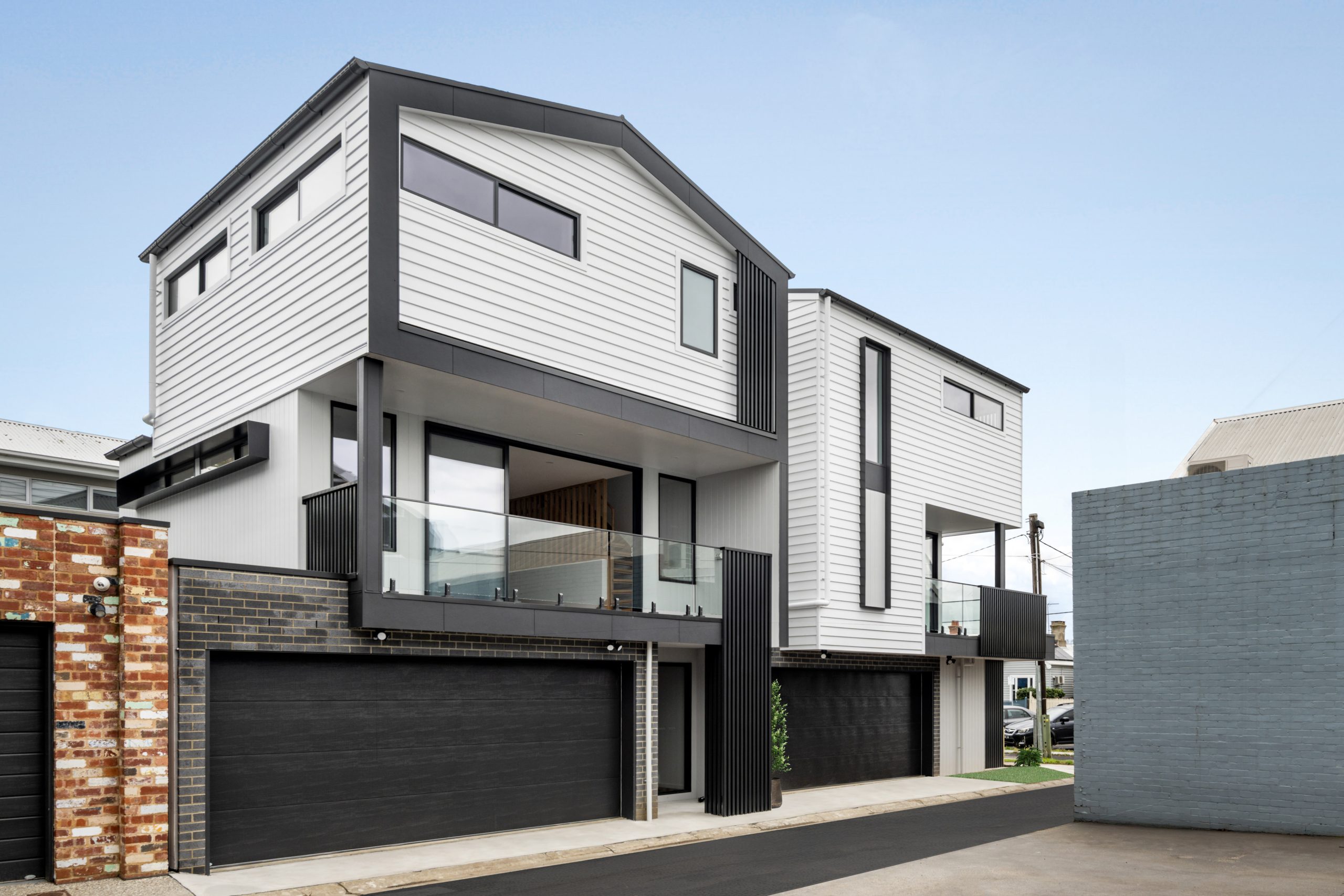 Townhouse Development South Geelong – Three-Storey Townhouse Facade With Charcoal-Framed Glazing And Glass Balustrade Balconies