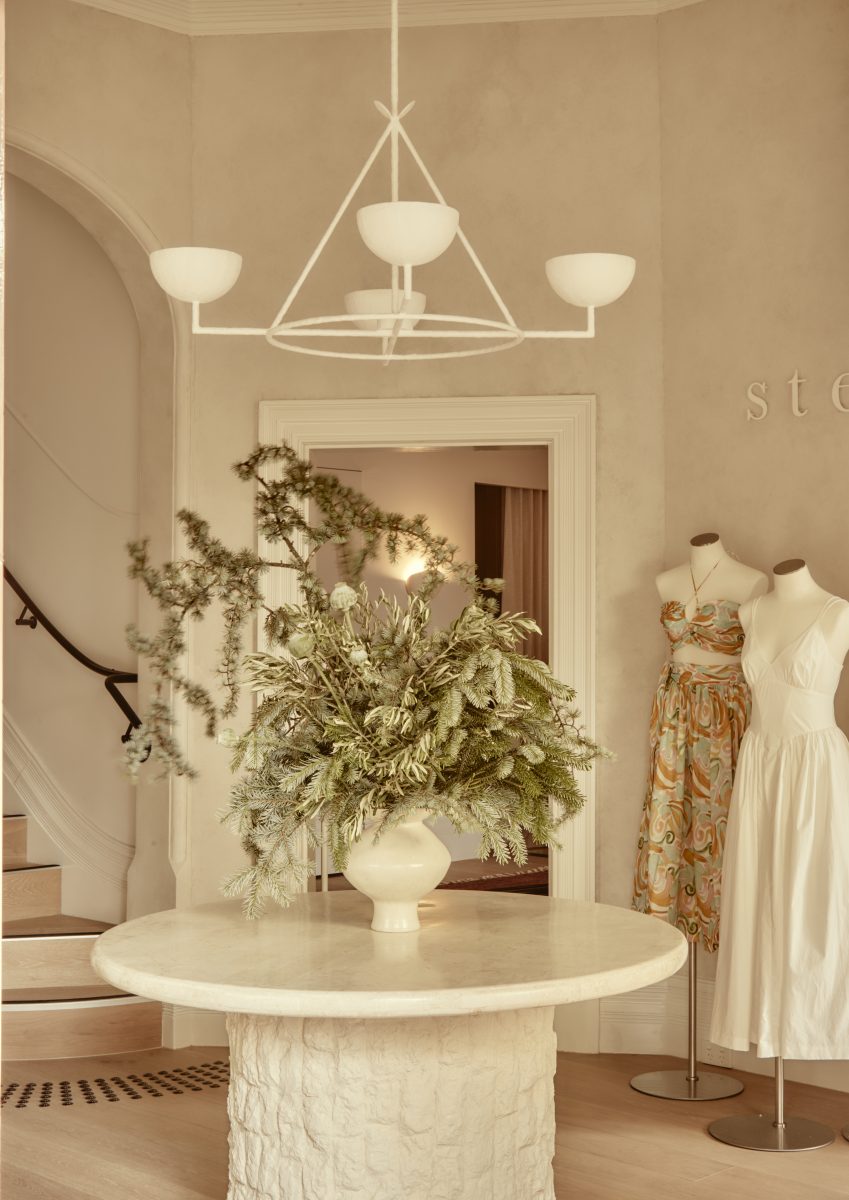A High-End Retail Interior In Hawthorn Featuring An Arched Entryway, Custom Sculptural Stone Plinth, And Venetian Plaster Finishes By Fox Building Group.