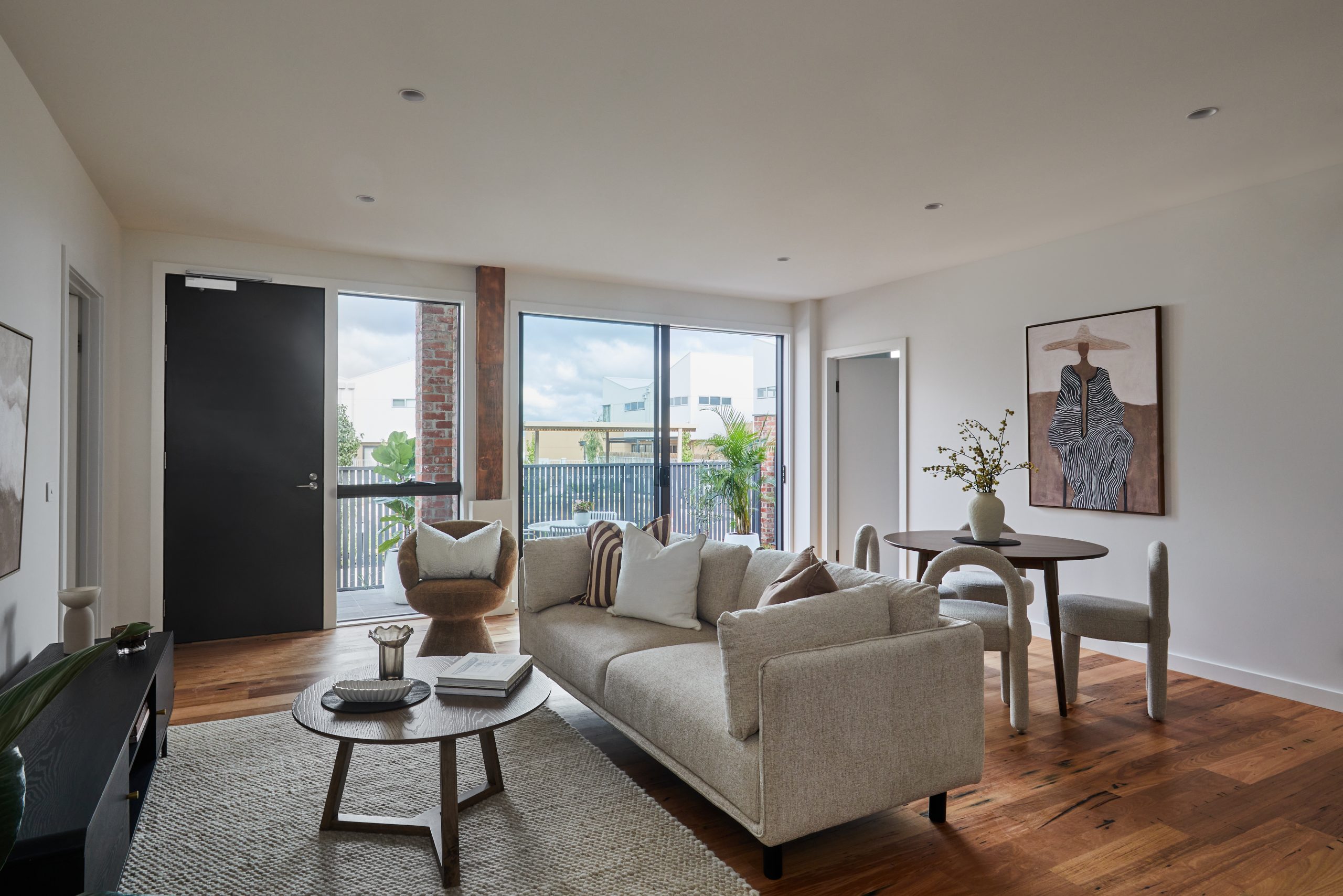 Ground-Floor Living Area Featuring Salvaged Hardwood Timber Floors, Direct Terrace Access, And Connection To A Communal Courtyard.