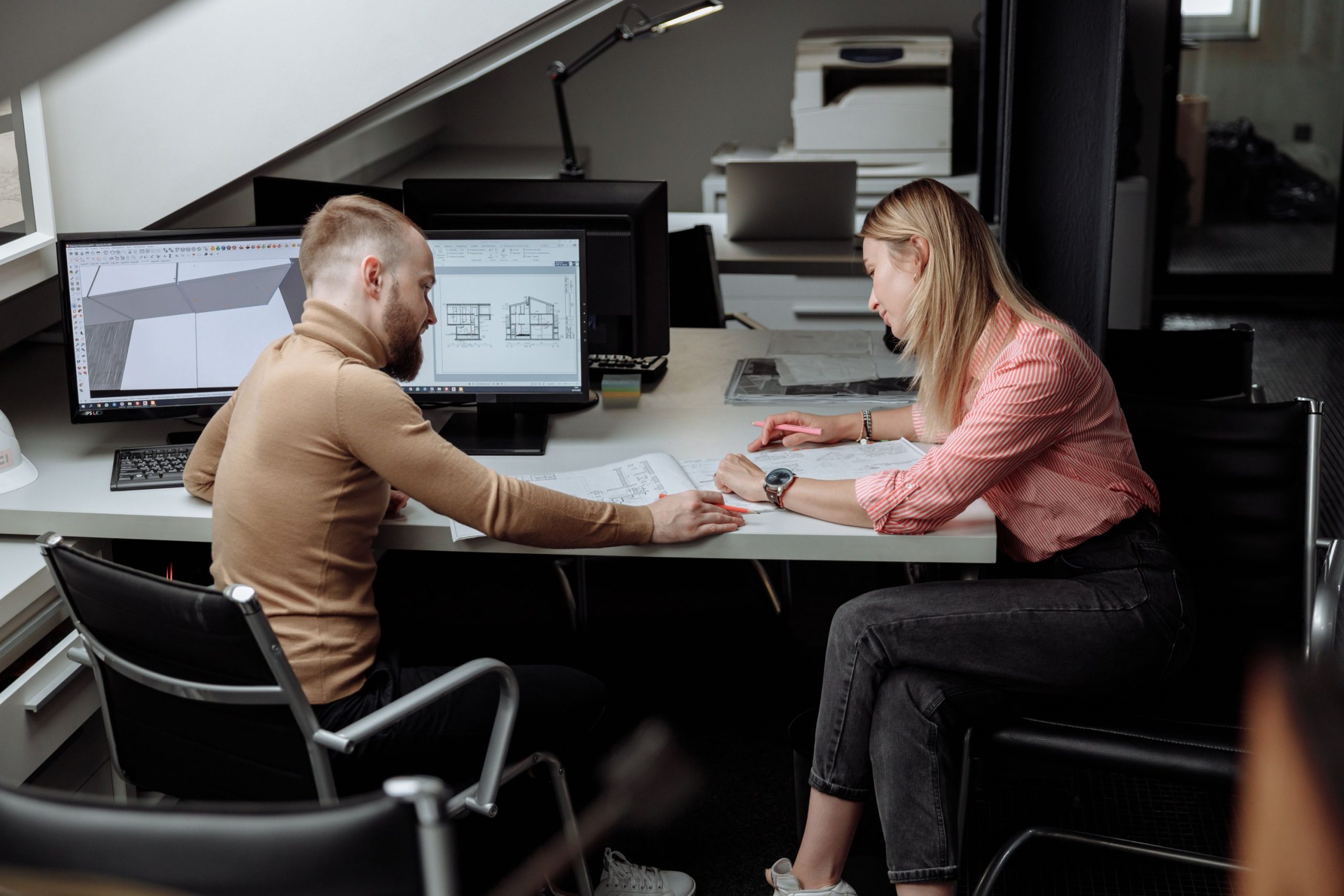 Builder and designer reviewing plans together during Early Contractor Involvement in Victoria